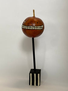 A Mini Pumpkin Gourd on a Stand