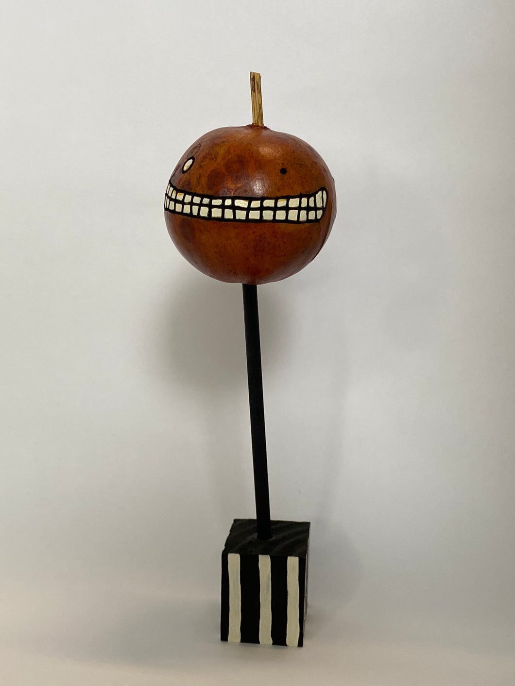 A Mini Pumpkin Gourd on a Stand